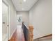 Bright upstairs hallway boasts hardwood floors and black railing at 1095 Tucker Ave # 503, Atlanta, GA 30310