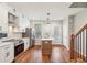 Well-lit kitchen boasts stainless appliances, white cabinets, island, and hardwood floors at 1095 Tucker Ave # 503, Atlanta, GA 30310