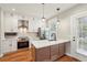 Modern kitchen features white cabinets, stainless steel appliances, quartz counters and wood flooring at 1095 Tucker Ave # 503, Atlanta, GA 30310