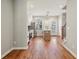 Modern kitchen with stainless steel appliances, white cabinets, island with sink, and hardwood flooring at 1095 Tucker Ave # 503, Atlanta, GA 30310