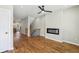 Bright living room with hardwood floors, modern fireplace, ceiling fan, and staircase at 1095 Tucker Ave # 503, Atlanta, GA 30310