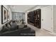 A cozy living room features a gray couch, a round table, and a large entertainment center with shelves at 1095 Tucker Ave # 503, Atlanta, GA 30310