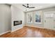 Stylish living room featuring hardwood floors, a modern fireplace, and large windows for natural light at 1095 Tucker Ave # 503, Atlanta, GA 30310