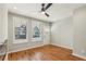 Bright living room with hardwood floors, two windows, and a modern fan at 1095 Tucker Ave # 503, Atlanta, GA 30310