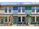 Street view showcases modern townhomes with unique colorful exteriors and covered front entrances at 1095 Tucker Ave # 503, Atlanta, GA 30310