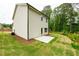 Back exterior view shows spacious level yard and concrete patio at 1800 Forkview Ct, Lawrenceville, GA 30044