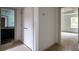 Hallway view featuring closet doors leading to a bathroom and bedroom with natural light at 1800 Forkview Ct, Lawrenceville, GA 30044