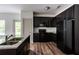 Modern kitchen featuring dark cabinets, stainless steel appliances, and granite countertops at 1800 Forkview Ct, Lawrenceville, GA 30044