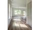 Open living room with hardwood floors, natural light, and modern chandelier at 1800 Forkview Ct, Lawrenceville, GA 30044