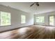 Sun-filled open living room with wood floors, large windows and access to a back door at 1800 Forkview Ct, Lawrenceville, GA 30044