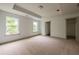 Spacious main bedroom with a tray ceiling, neutral carpet, and ample natural light at 1800 Forkview Ct, Lawrenceville, GA 30044