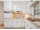 Close-up of the kitchen showcasing white cabinetry, laminate countertops and stainless steel sink at 3501 Montreal Way, Tucker, GA 30084