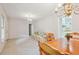 Open-concept living and dining area with chandelier, sofa, and view into kitchen at 3501 Montreal Way, Tucker, GA 30084