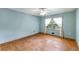 This bedroom has hardwood floors, light blue walls, ceiling fan and a window with curtains at 618 Buchanan Hwy, Dallas, GA 30157