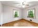 The bedroom features wallpapered walls, hardwood floors and two windows with curtains at 618 Buchanan Hwy, Dallas, GA 30157