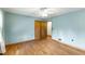 This bedroom has hardwood floors, light blue walls, ceiling fan and closet at 618 Buchanan Hwy, Dallas, GA 30157