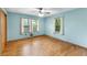 The bedroom has hardwood floors, light blue walls and two large windows at 618 Buchanan Hwy, Dallas, GA 30157