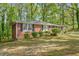 Charming brick home featuring dark shutters, a well-manicured lawn, and established landscaping at 618 Buchanan Hwy, Dallas, GA 30157