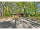 A cozy, single-story brick home with a convenient carport nestled in a wooded, green lot at 618 Buchanan Hwy, Dallas, GA 30157
