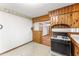 The kitchen leads to another room and features knotty pine cabinetry at 618 Buchanan Hwy, Dallas, GA 30157