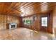 Living room features wood-paneled walls, hardwood floors, fireplace, and natural light at 618 Buchanan Hwy, Dallas, GA 30157
