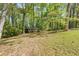 Beautifully landscaped front yard with mature trees providing shade and privacy for the home at 618 Buchanan Hwy, Dallas, GA 30157