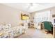 Bright bedroom featuring carpeted floors, a ceiling fan, and a window letting in natural light at 7840 Highway 101, Rockmart, GA 30153