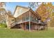 Charming home with multi-level decks and porches surrounded by lush greenery and mature trees at 7840 Highway 101, Rockmart, GA 30153