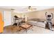 Spacious living room with carpeted floors, a ceiling fan, and fitness equipment at 7840 Highway 101, Rockmart, GA 30153
