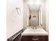 Stylish powder room with a modern vanity, mirror, decorative accents, and an elegant towel rack at 7840 Highway 101, Rockmart, GA 30153