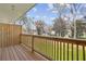 Outdoor wooden deck with views of a verdant yard and mature trees under a bright sky at 1095 Tucker Ave # 408, Atlanta, GA 30310