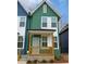 Charming green two-story home with inviting front porch and beautifully painted facade at 1095 Tucker Ave # 408, Atlanta, GA 30310