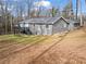 Exterior of a gray house in a backyard showing the deck, steps and outdoor space at 1925 Commonwealth Ct, Cumming, GA 30041