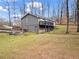 View of house exterior showing the backyard, steps, and access to basement at 1925 Commonwealth Ct, Cumming, GA 30041