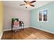 Bright bedroom featuring hardwood floors, neutral walls, a desk, and a large window at 1925 Commonwealth Ct, Cumming, GA 30041