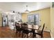 Cozy dining room featuring a wooden table, chairs, and adjacent kitchen with modern appliances at 1925 Commonwealth Ct, Cumming, GA 30041