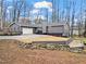 Well-maintained gray single story home with landscaped yard featuring a tiered stone retaining wall at 1925 Commonwealth Ct, Cumming, GA 30041