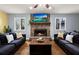Bright living room showcasing hardwood floors, two sofas, and a cozy stone fireplace at 1925 Commonwealth Ct, Cumming, GA 30041