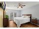 Tranquil bedroom with a queen-size bed, ceiling fan, and doors to a private balcony at 1925 Commonwealth Ct, Cumming, GA 30041