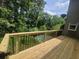 View of a backyard deck overlooking a lush green area with views of the in-ground pool at 225 Nacoochee Dr, Woodstock, GA 30188