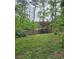 Spacious backyard featuring a classic wooden fence providing privacy and a lush green lawn at 225 Nacoochee Dr, Woodstock, GA 30188
