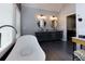 Bright bathroom with a modern vanity, stylish mirrors, and a soaking tub, perfect for relaxation at 225 Nacoochee Dr, Woodstock, GA 30188