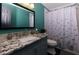 Bright bathroom features a granite vanity and a shower with a playful, themed shower curtain at 225 Nacoochee Dr, Woodstock, GA 30188