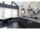 Bathroom featuring a double sink vanity, complemented by a freestanding tub for a spa-like experience at 225 Nacoochee Dr, Woodstock, GA 30188