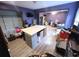 Bedroom with purple walls, ceiling fan, closet, desk, and light hardwood floors at 225 Nacoochee Dr, Woodstock, GA 30188