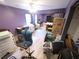 Bedroom with purple walls, ceiling fan, closet, desk, and light hardwood floors at 225 Nacoochee Dr, Woodstock, GA 30188