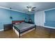 Stylish bedroom featuring a modern bed frame, pendant lighting, and a large window at 225 Nacoochee Dr, Woodstock, GA 30188