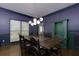 Dining room with purple walls, a green built-in cabinet and traditional-style chairs at 225 Nacoochee Dr, Woodstock, GA 30188