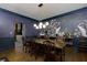 Dining room with peacock wallpaper accent wall, unique light fixture, and access to kitchen at 225 Nacoochee Dr, Woodstock, GA 30188