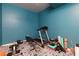 Workout room with treadmill, bench, weights, and patterned floor perfect for home fitness at 225 Nacoochee Dr, Woodstock, GA 30188